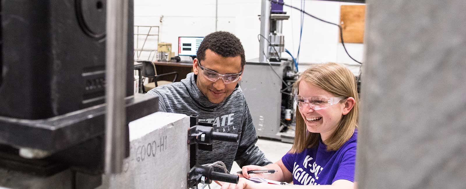 Two students work in the structures lab.